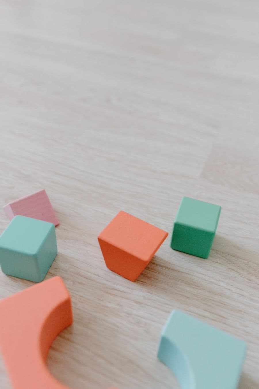 Colorful wooden play blocks arranged on a light surface